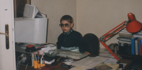 6 years old Tivadar in sunglasses sitting in front of a computer